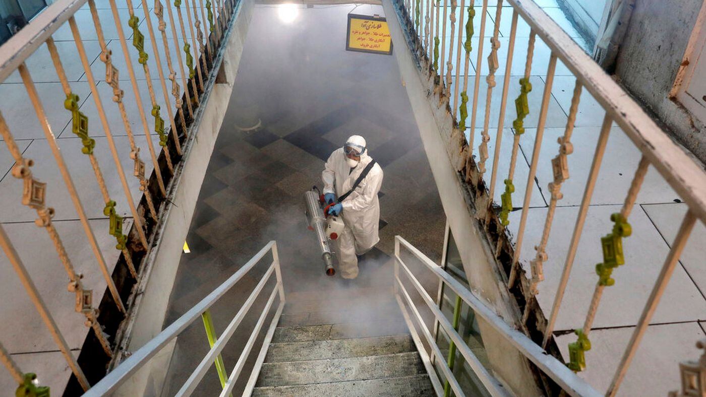 A firefighter disinfects a traditional shopping center to help prevent the spread of the new coronavirus in northern Tehran, Iran, Friday, March, 6, 2020. A Health Ministry spokesman warned authorities could use unspecified “force” to halt travel between major cities. (AP Photo/Ebrahim Noroozi)